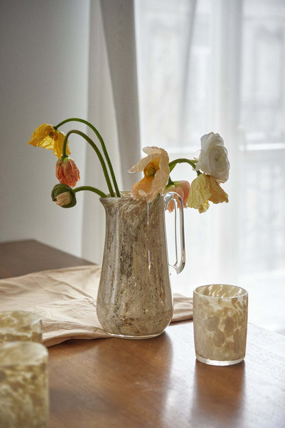 Hand Blown Glass Tumbler in marble beige with flowers in a textured pitcher on a wood table on Tampa Home & Garden Store