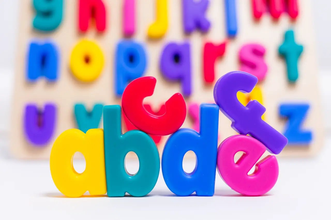 xyz Find & Fit Puzzle colorful plastic alphabet letters in front of a wooden puzzle board on Tampa Home & Garden Store