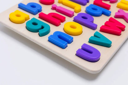 xyz Find & Fit Puzzle colorful plastic letter pieces arranged on a light wooden board on Tampa Home & Garden Store