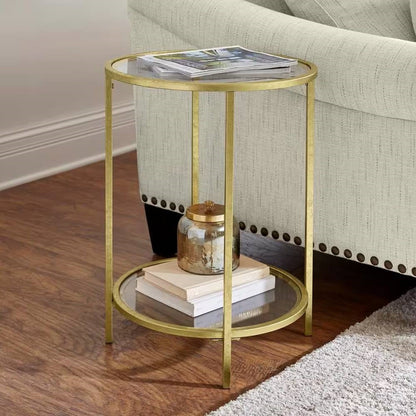Mesa auxiliar redonda con acento, metal dorado, tapa de cristal, estante inferior.