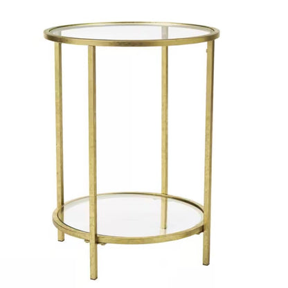 Mesa auxiliar redonda con acento, metal dorado, tapa de cristal, estante inferior.