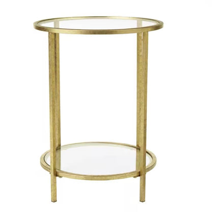Mesa auxiliar redonda con acento, metal dorado, tapa de cristal, estante inferior.