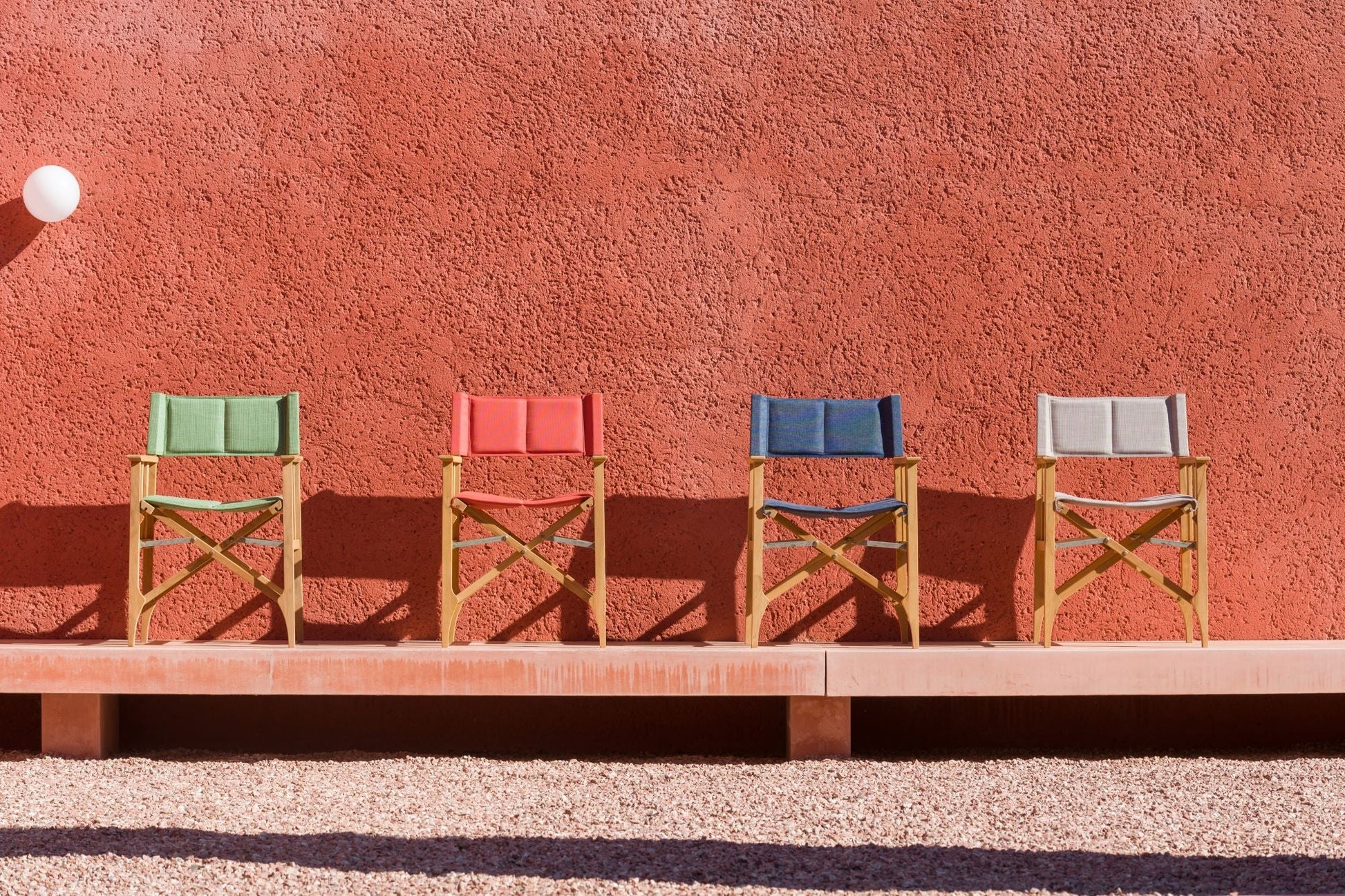 Zircon teak director chair set of four with multicolor fabric on wooden frames against wall on Tampa Home & Garden Store