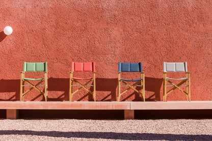 Zircon teak director chair set of four with multicolor fabric on wooden frames against wall on Tampa Home & Garden Store