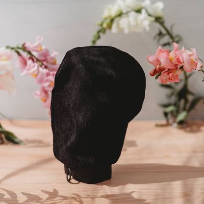Face & Body Self Tanning Bundle Glow Collection black hood on display with floral backdrop on Tampa Home & Garden Store