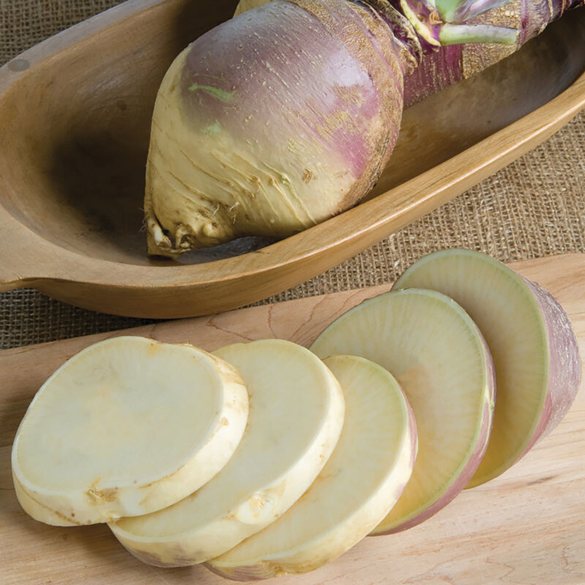 Laurentian rutabaga root with purple skin and pale flesh, several sliced rounds on a wooden board on Tampa Home & Garden Store