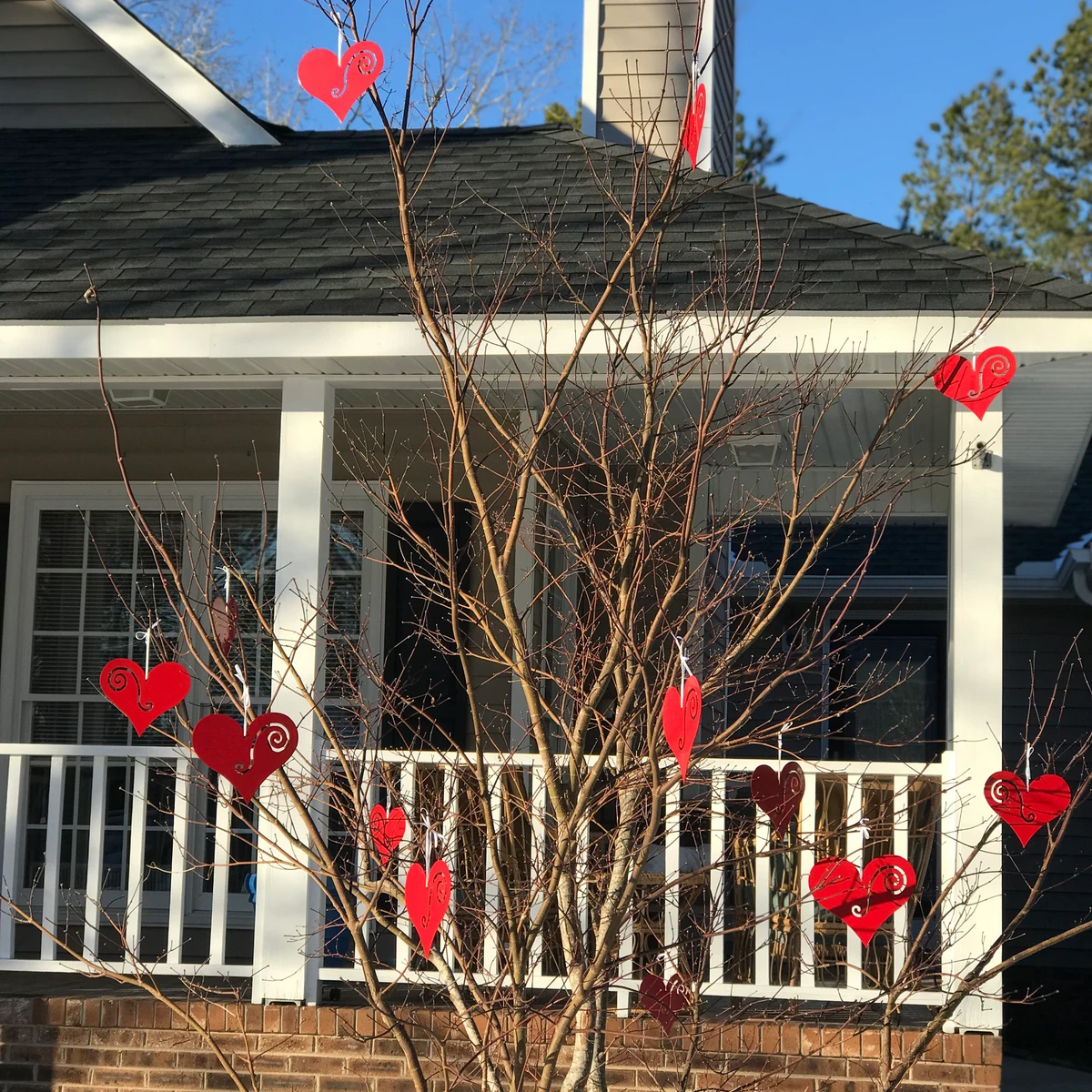 Hanging Heart Tree Ornaments set of 12 red hearts with swirl accents on a bare tree on Tampa Home & Garden Store