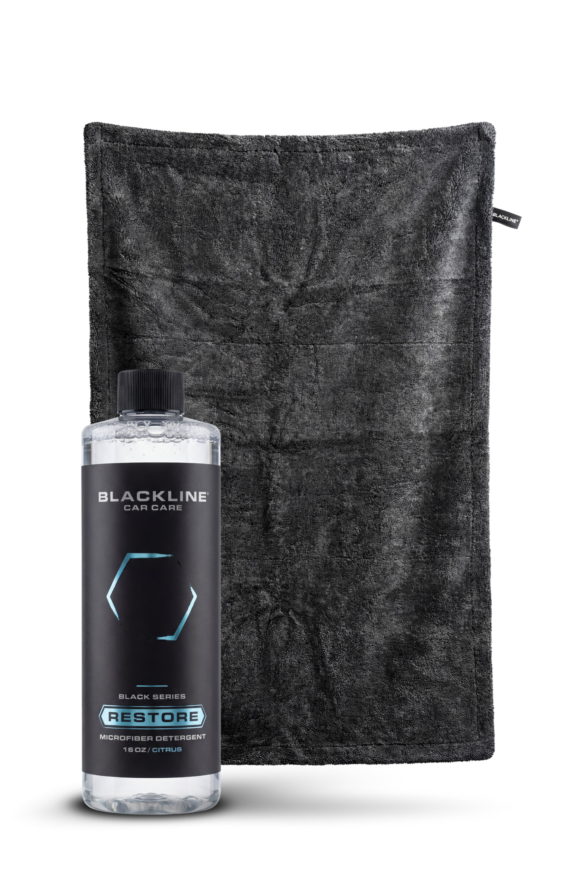 Blackline Restore microfiber detergent bottle beside a black microfiber towel on Tampa Home & Garden Store