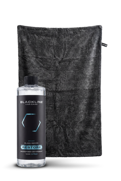 Blackline Restore microfiber detergent bottle beside a black microfiber towel on Tampa Home & Garden Store