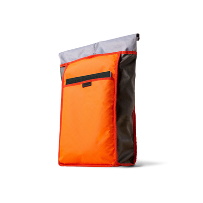Rolltop backpack The Brown Buffalo with bright orange front pocket, gray top panel, red trim on Tampa Home & Garden Store