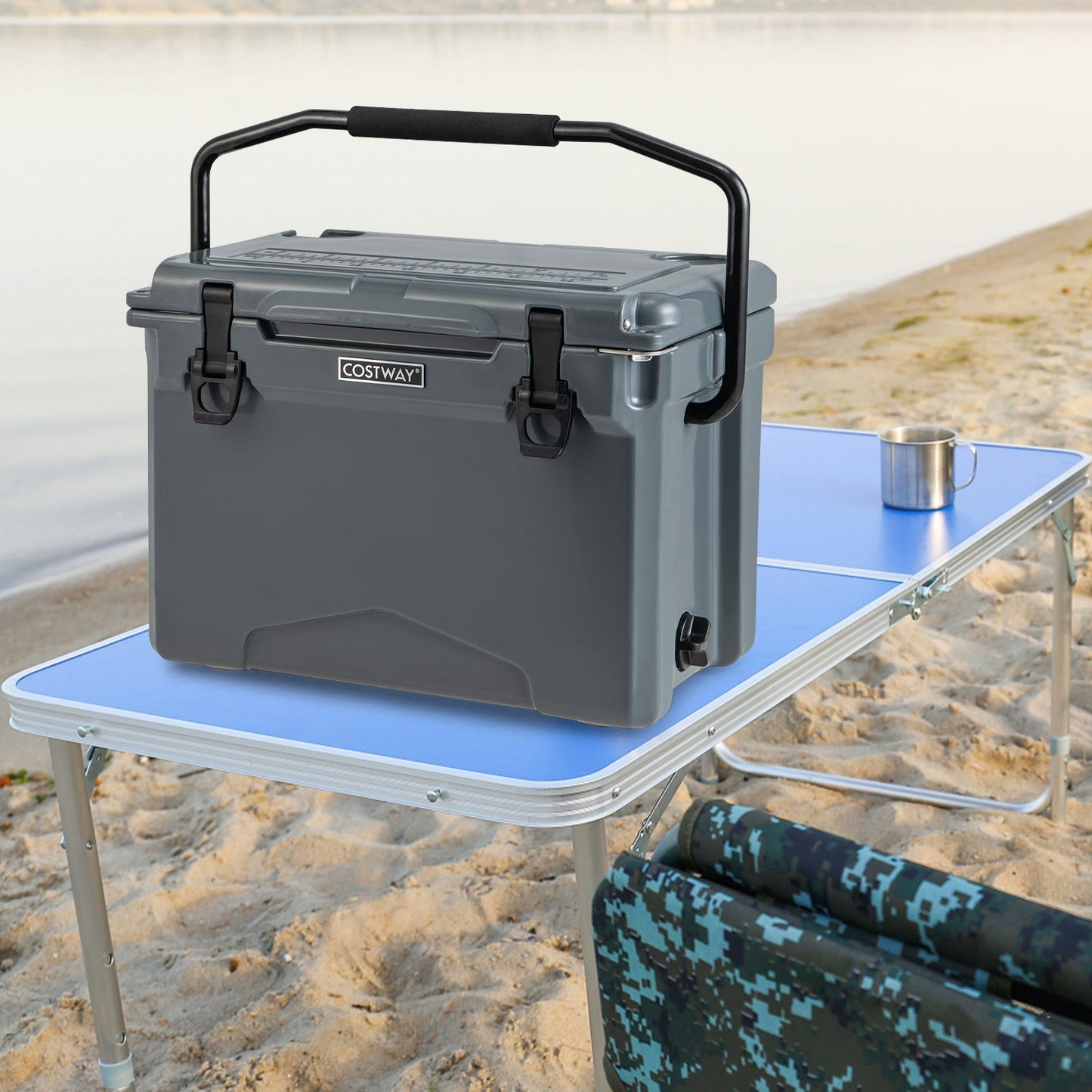 25 QT hard cooler with aluminum handle, gray Costway brand on beach beside a blue table on Tampa Home & Garden Store