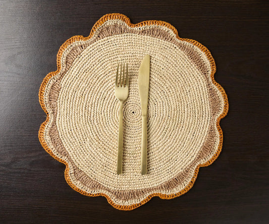 Round raffia placemat with gold-toned cutlery; beige center, orange-brown border on Tampa Home & Garden Store
