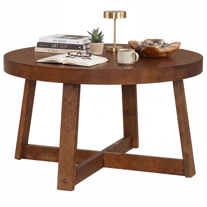 Round coffee table 30 inch with solid wood legs in warm brown finish, with books, plant, mug on Tampa Home & Garden Store