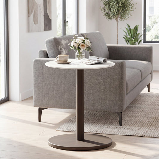 Round marble top side table with brown pedestal base beside a gray sofa in a modern living room on Tampa Home & Garden Store