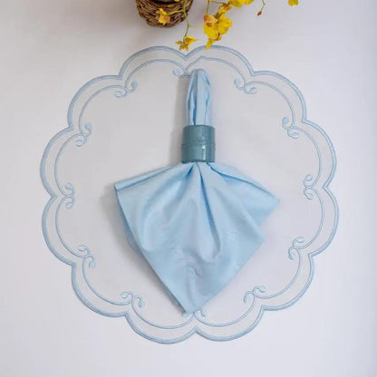 Royal placemat by Talah Home with light blue color and elegant scalloped blue border on Tampa Home & Garden Store