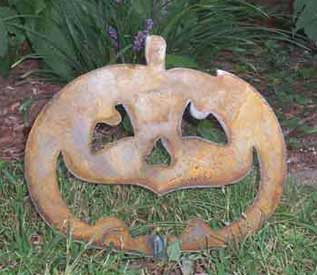 Jack O Lantern pumpkin garden stake with rusty metal finish and face for Halloween decor on Tampa Home & Garden Store