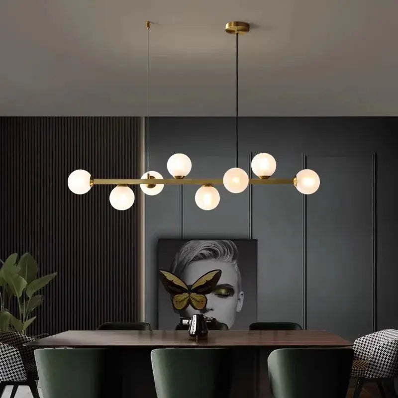 DecorBites LED pendant chandelier with gold bar and globe bulbs over dining table on Tampa Home & Garden Store