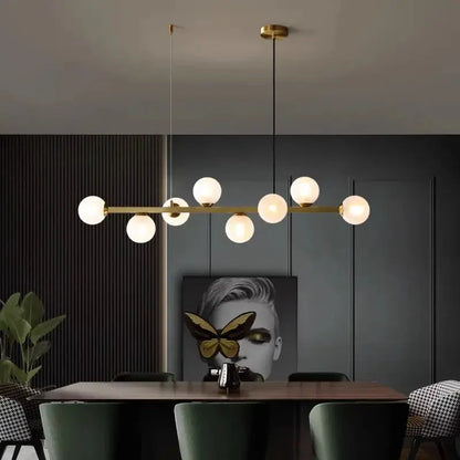 DecorBites LED pendant chandelier with gold bar and globe bulbs over dining table on Tampa Home & Garden Store