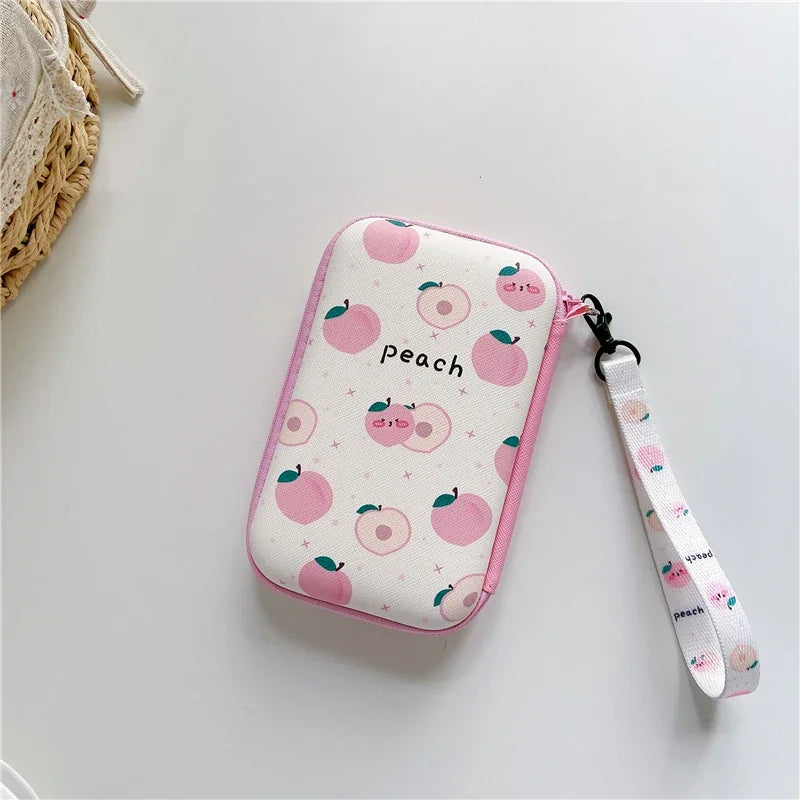 Peach-pattern lanyard case with pink trim for handheld consoles; peach-print wrist strap on Tampa Home & Garden Store