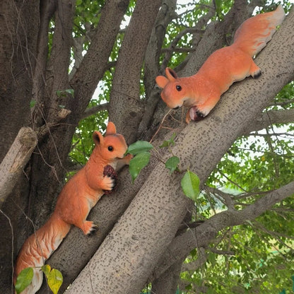 Perfecsy orange resin squirrel figurines, two tree climbers hugging on a branch with acorn on Tampa Home & Garden Store