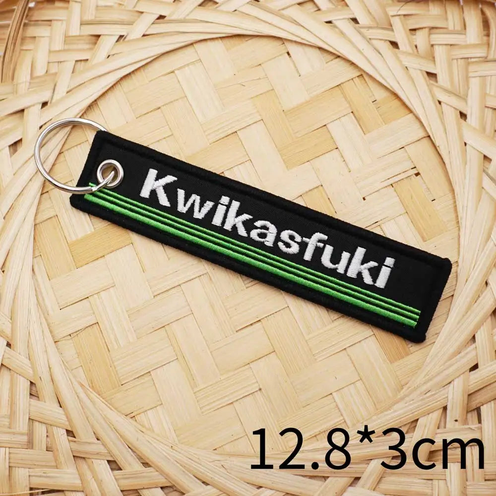 Motorcycle keychain, black fabric with Kwikasfuki embroidery and green stripes, metal ring on Tampa Home & Garden Store