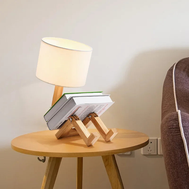 Perfecsy robot-shaped table lamp with wooden legs and white fabric shade, E27 foldable desk light on a round table with books on Tampa Home & Garden Store