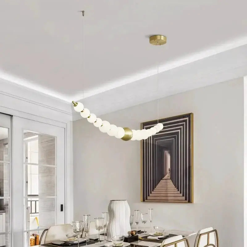DecorBites LED pendant chandelier with white spheres and gold accents over dining area on Tampa Home & Garden Store