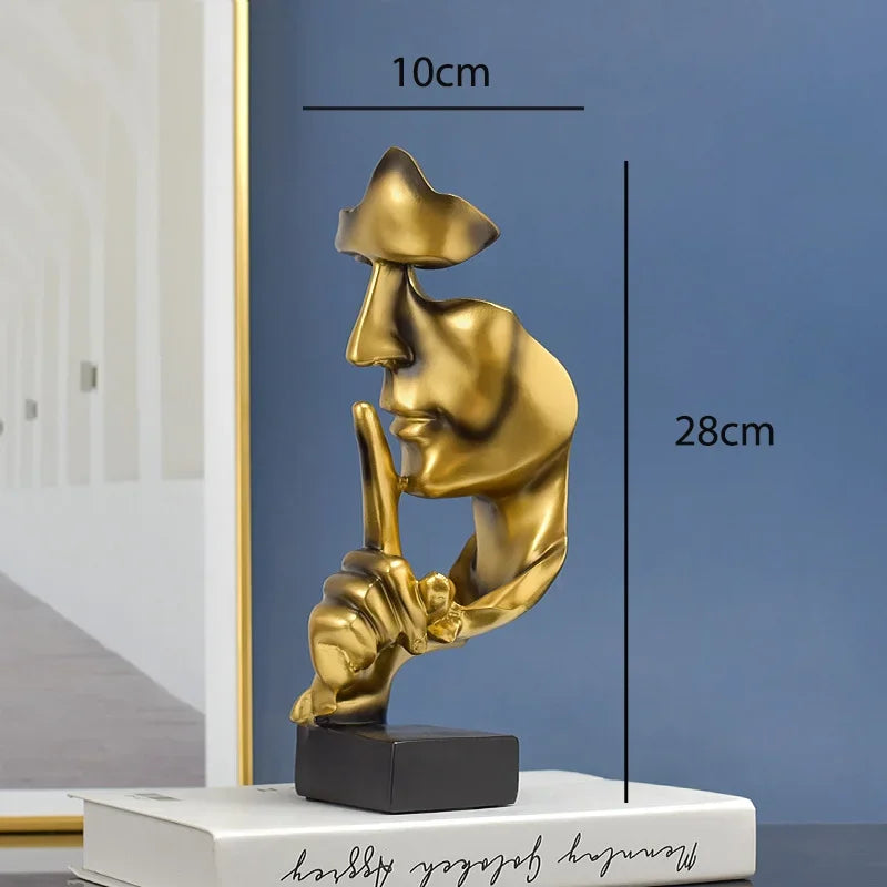 Gold resin thinker statue with finger to lips, abstract face sculpture on black base decor on Tampa Home & Garden Store