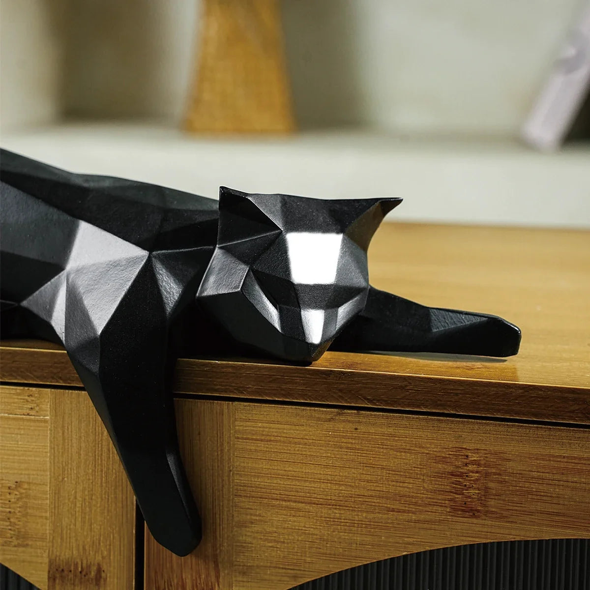 Perfecsy black geometric cat statue with faceted design lounging on a desk for modern decor on Tampa Home & Garden Store