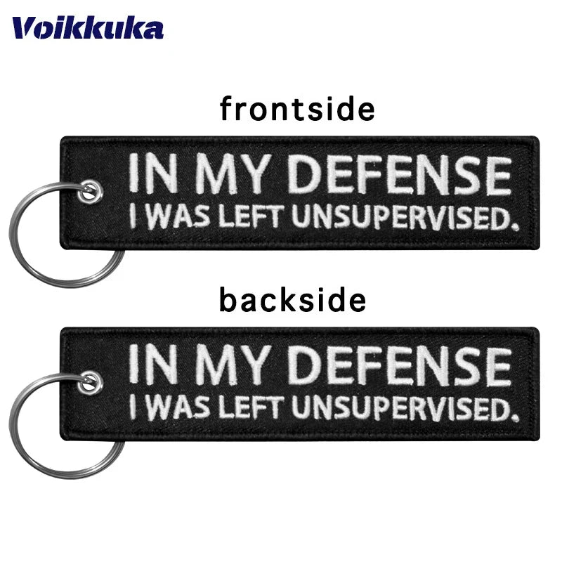 Two-sided black motorcycle keychain with white text IN MY DEFENSE I WAS LEFT UNSUPERVISED on Tampa Home & Garden Store