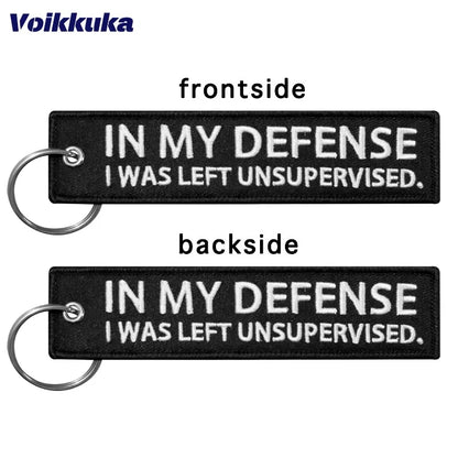 Two-sided black motorcycle keychain with white text IN MY DEFENSE I WAS LEFT UNSUPERVISED on Tampa Home & Garden Store