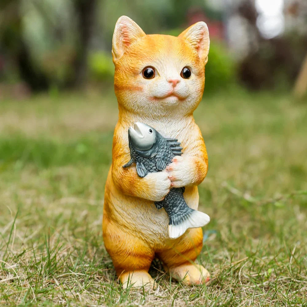 Orange cat figurine holding a fish for outdoor garden decor on Tampa Home & Garden Store