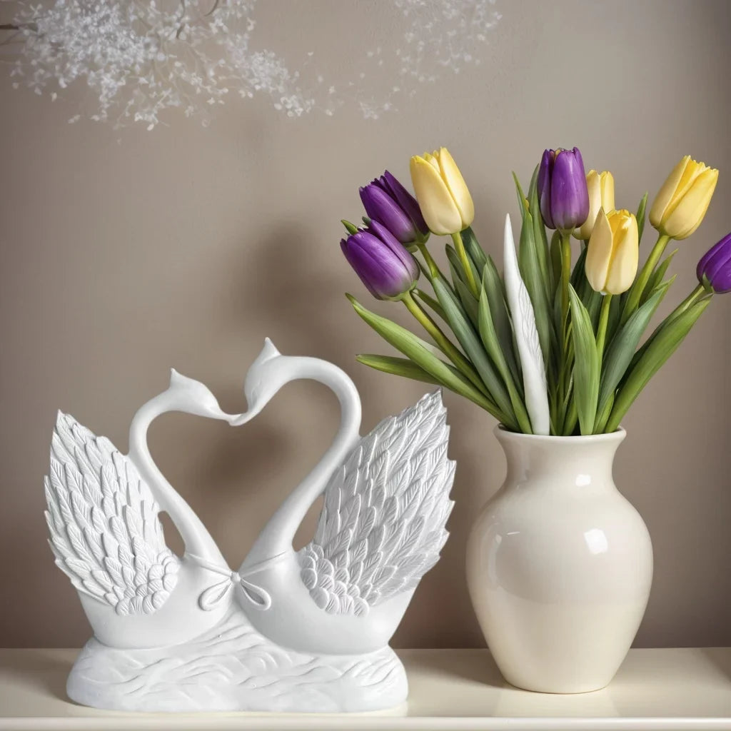 Perfecsy heart-to-heart swan statue, white ceramic with detailed wings, beside a tulip vase on Tampa Home & Garden Store