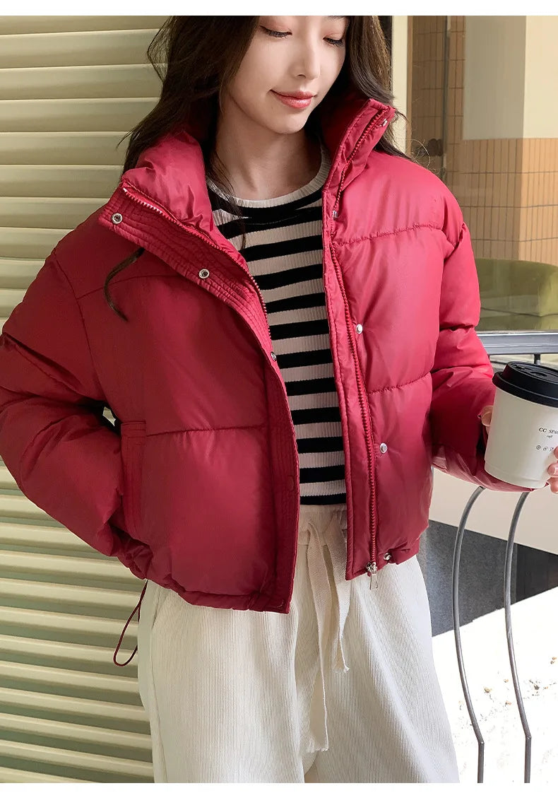 Womens cropped red cotton-padded puffer jacket with zip and snap front, over striped top on Tampa Home & Garden Store