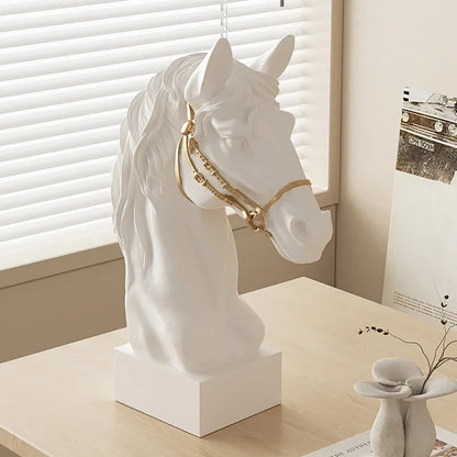 Galloping horse head resin sculpture with gold bridle on a white pedestal on Tampa Home & Garden Store