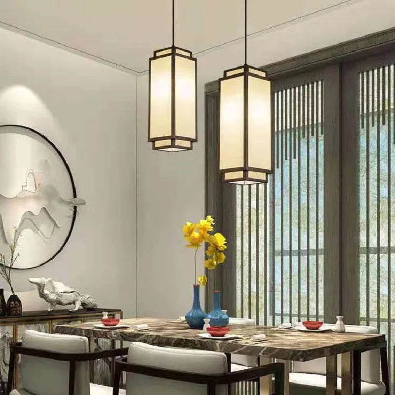 Pendant lights with cream fabric shades, twin lanterns over marble dining table on Tampa Home & Garden Store