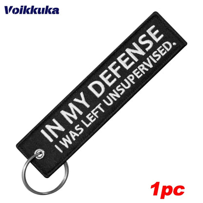 Left Unsupervised motorcycle keychain by BikerZoneZ, black fabric with embroidery ring on Tampa Home & Garden Store