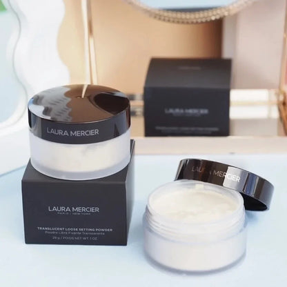 Laura Mercier translucent loose setting powder jars, two with glossy black lids on black boxes on Tampa Home & Garden Store