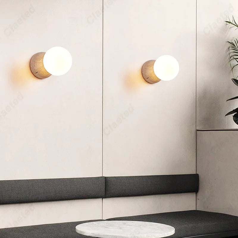 Retro LED Cream Wind Tunnel Stone Lamp pair wall sconces with globes above gray sofa on Tampa Home & Garden Store