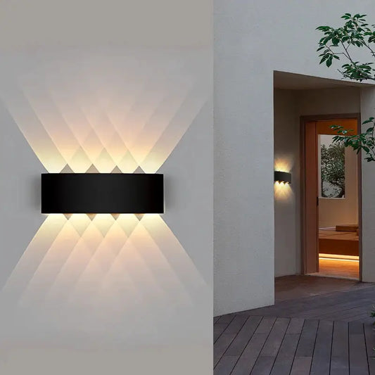 LED outdoor wall light Moktan Sabai, black rectangular fixture with warm porch glow on Tampa Home & Garden Store