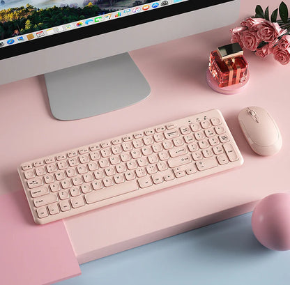 Purple wireless keyboard and mouse set by FLIPSTYLEZLLC on a pink desk beside an iMac on Tampa Home & Garden Store