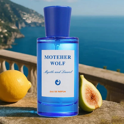 Mother Wolf blue glass perfume bottle with Myrtle and Laurel beside lemon and fig backdrop on Tampa Home & Garden Store