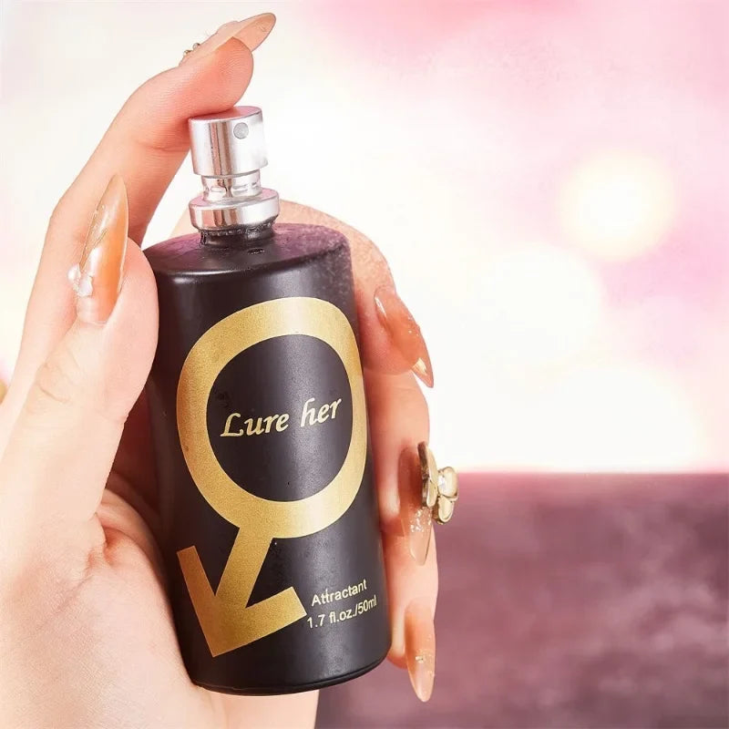 Pheromone perfume bottle Lure her black matte 50 ml with gold circular label held in hand on Tampa Home & Garden Store