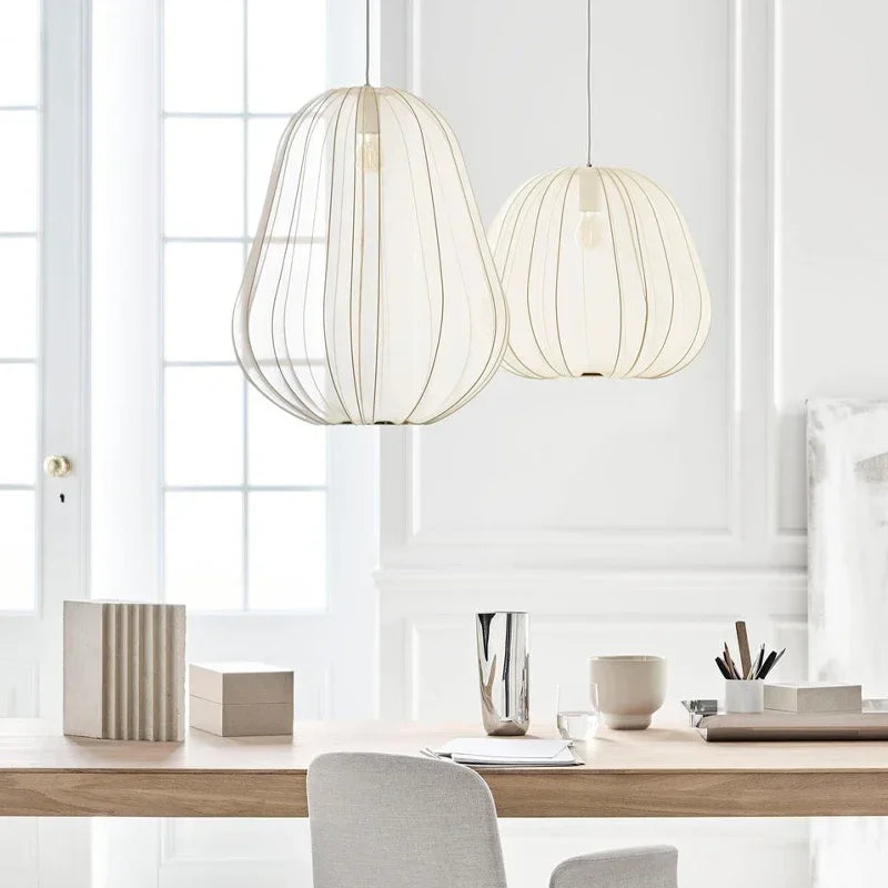 DecorBites LED Art Chandelier pendant lights, two white shell fixtures over a wooden table on Tampa Home & Garden Store