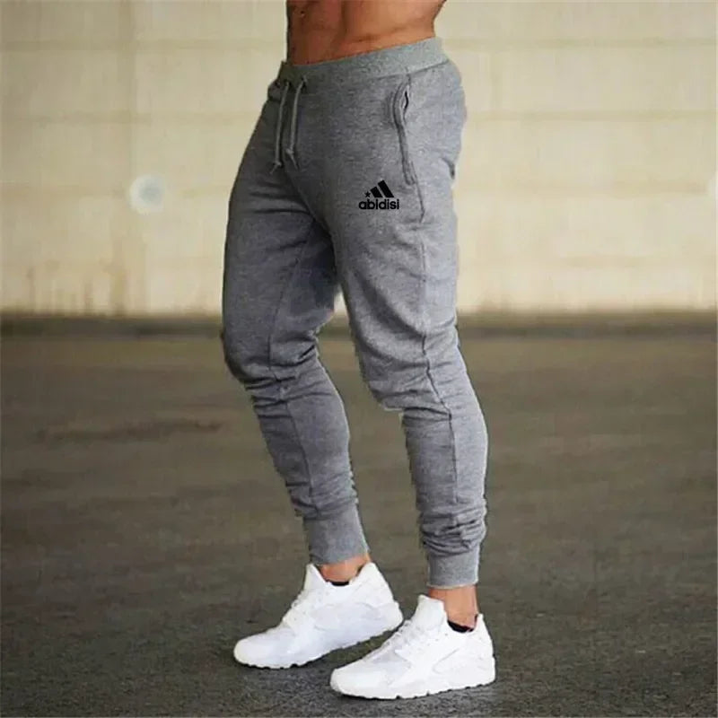 Men's grey jogger pants with drawstring waist and cuffed ankles Adidas logo on thigh on Tampa Home & Garden Store