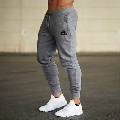 Men's grey jogger pants with drawstring waist and cuffed ankles Adidas logo on thigh on Tampa Home & Garden Store
