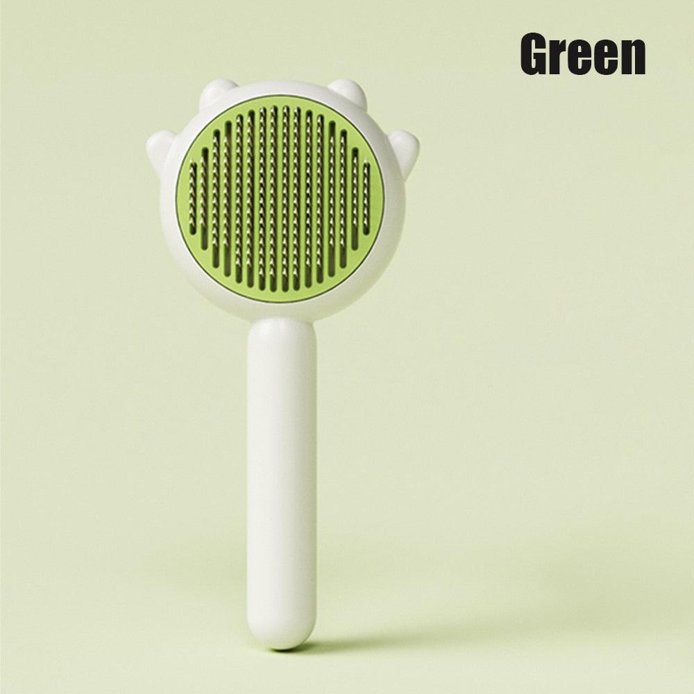 Cat comb massage brush with green circular head and white handle for dogs and cats on Tampa Home & Garden Store
