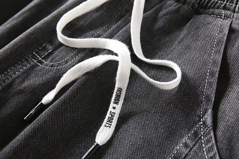 Men's wide-leg jeans in dark denim with white drawstring and metal aglets on Tampa Home & Garden Store