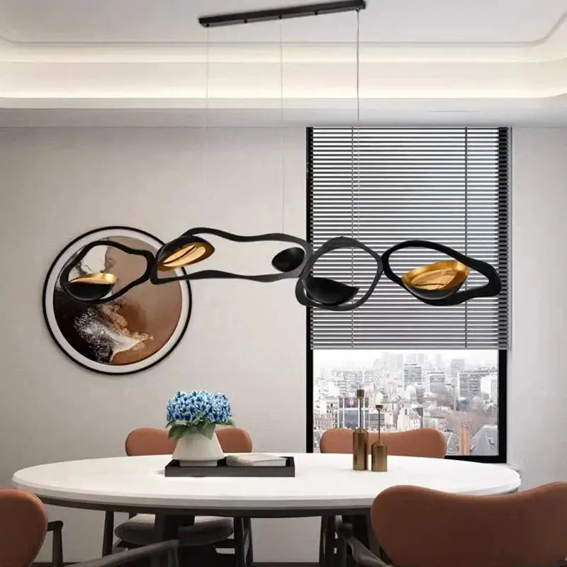 DecorBites LED Pendant Chandelier with black arcs and gold interiors over a white round table on Tampa Home & Garden Store