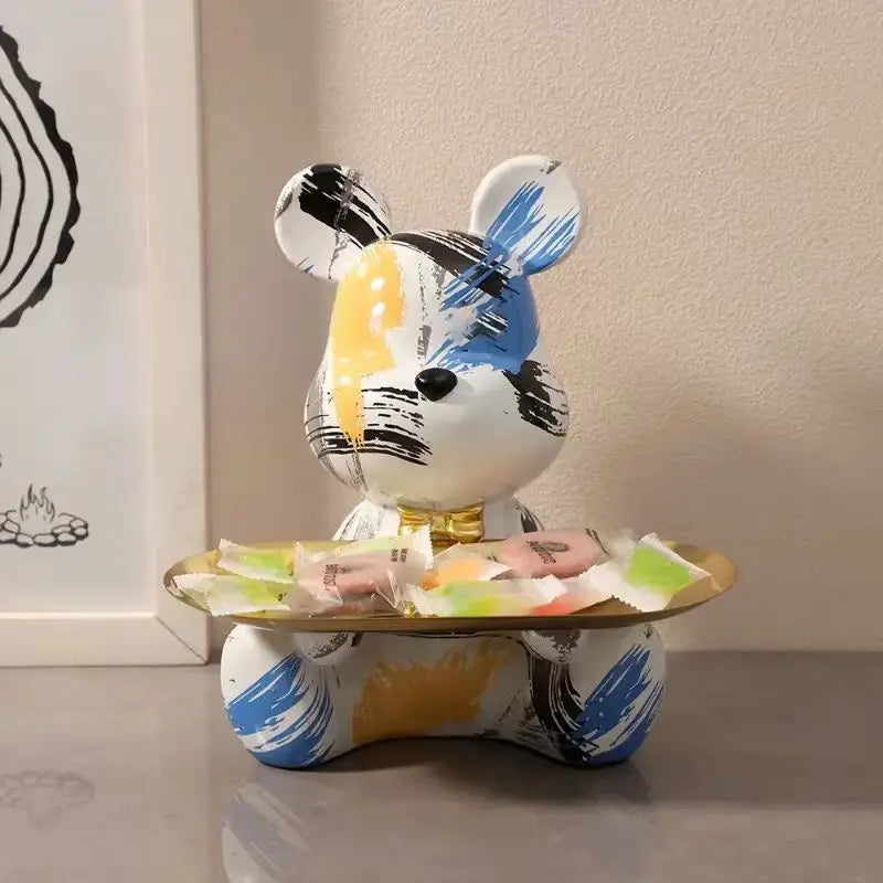 Graffiti bear figurine with blue, black and yellow brush strokes and a gold candy tray on Tampa Home & Garden Store
